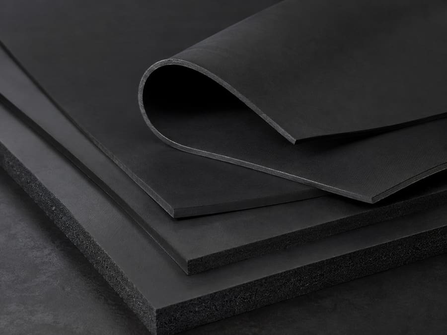 Layered matte black industrial rubber sheets.